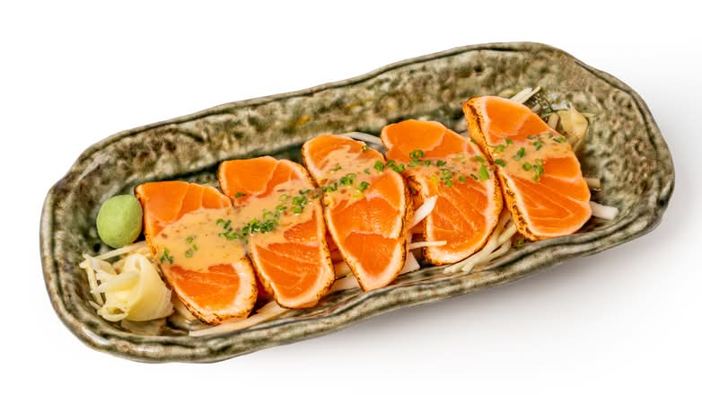 Thick slices of gently seared salmon with chives, ginger & wasabi.